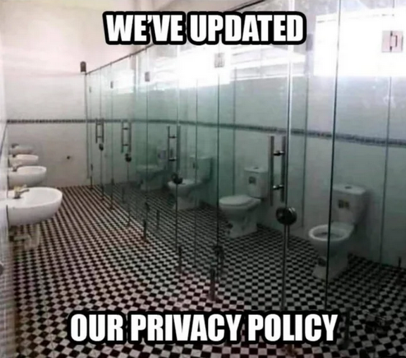 Public bathroom with clear glass walls and doors; text on the meme reads "we've updated our privacy policy"
